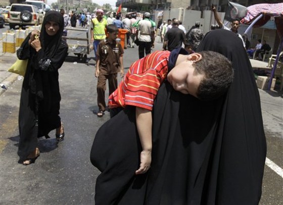 Shiite pilgrims walk toward the Imam Moussa al-Kadhim shrine for the annual commemoration of the saint's death, in the Shiite district of Kazimiyah, in Baghdad, Iraq, on Sunday.